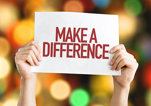 Person holding a Make a Difference sign above their head