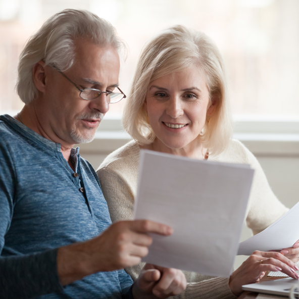 elderly couple reviewing documents